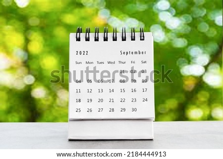 September 2022
 desk calendar for planners and reminders on a black table on the natural background green . Royalty-Free Stock Photo #2184444913