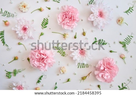 Pink pastel flowers mix and green leaves petals on white pastel floral feminine spring background. Summer flower shop floristic composition blossom decoration flatlay pattern. Top view above, flat