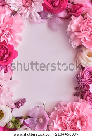 Many different pink flower mix frame floral background with white blank clear copy space. Blossom composition flatlay with copyspace, postcard design, spring greeting card template. Top view, flat