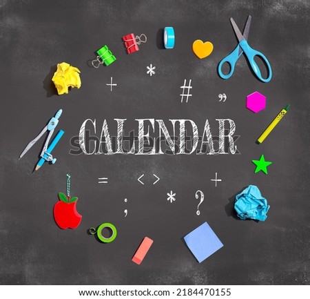 Calendar theme with school supplies on a chalkboard - flat lay