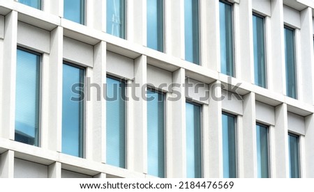 Simple generic office building detail, glass windows, closeup, modern business architecture details up close, simple background. City life, urban detail, business building wall, exterior up close Royalty-Free Stock Photo #2184476569