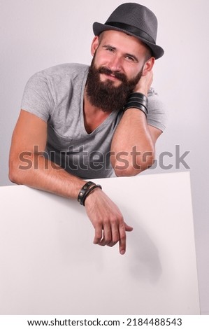 Young man leaning on the empty board