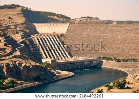 Dam, hydroelectric power plant and water reservoir on Euphrates river in Sanliurfa province, Turkiye Royalty-Free Stock Photo #2184492261