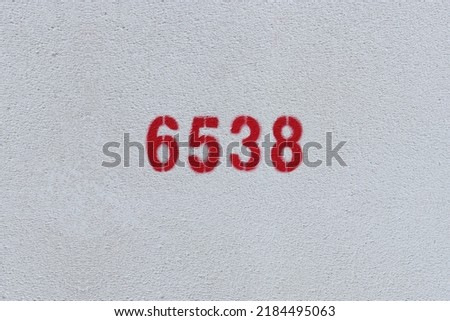 Red Number 6538 on the white wall. Spray paint.
