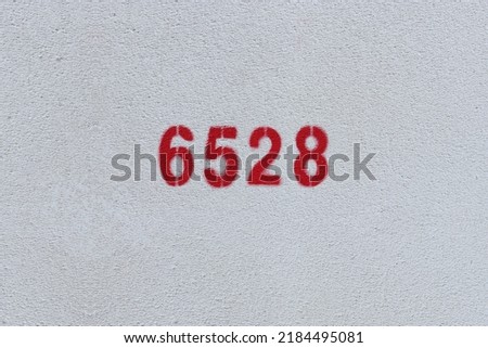Red Number 6528 on the white wall. Spray paint.

