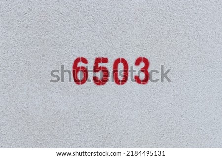 Red Number 6503 on the white wall. Spray paint.
