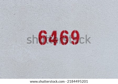 Red Number 6469 on the white wall. Spray paint.

