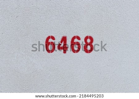 Red Number 6468 on the white wall. Spray paint.
