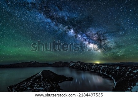 A brilliant Milky Way reflects in Crater Lake, captured on the Summer Solstice in Crater Lake National Park, Oregon. Royalty-Free Stock Photo #2184497535
