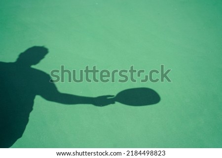 Silhouette outline of a man playing pickleball.        Royalty-Free Stock Photo #2184498823