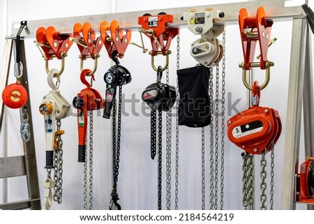 Close up various kind of industrial manual chain hoist such as hand pull and lever type for lifting object and reduce work load storage on hanger line Royalty-Free Stock Photo #2184564219