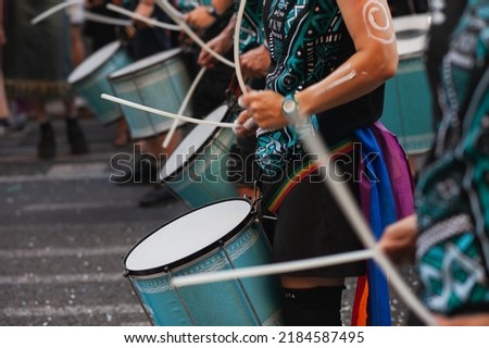 Music band playing drums in the street at public event. Drummers musicians playing music at Pride festival in June. Pride month march celebration. Queer lgbt community awareness. Royalty-Free Stock Photo #2184587495
