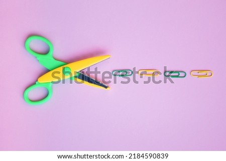 Back to school concept with school supplies, scissors, paper clips on pastel purple background. Top view with copy space. Flat lay.