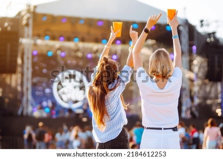 Two young woman with beer at beach party. Summer holiday, vacation concept. Friendship and celebration concept. Royalty-Free Stock Photo #2184612253