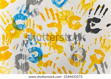 bright prints of children's hands from paint on the wall, background, texture, horizontal format