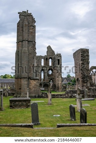 Ruins of Elgin cathedral with gravestones around it Royalty-Free Stock Photo #2184646007