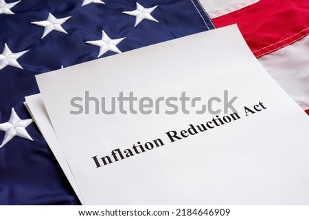 Papers with the Inflation Reduction Act and US flag. Royalty-Free Stock Photo #2184646909