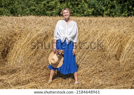 Portrait of a middle-aged woman posing in a wheat field