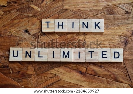 think unlimited text om wooden square, business quotes