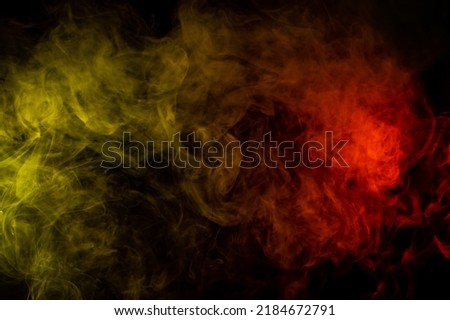 Red-yellow smoke spreads on a black background.