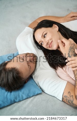 Smiling woman lies on the chest of a man