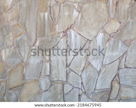 Textured flagstone wall. Textured sandstone wall masonry cladding. Full screen image. Not seamless texture.