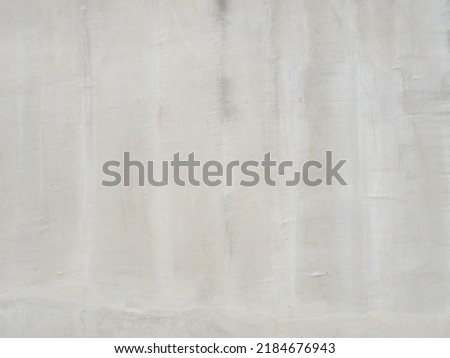 Putty white wall texture. White plastered non-uniformly coated wall. Full screen photo. Not a seamless texture.