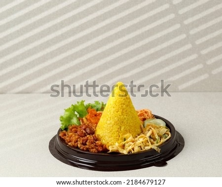 Small Cone Shaped Yellow Rice Or Tumpeng Mini Nasi Kuning. Indonesian Festive Food for Indoneia Independence Day 17 Agustus Royalty-Free Stock Photo #2184679127