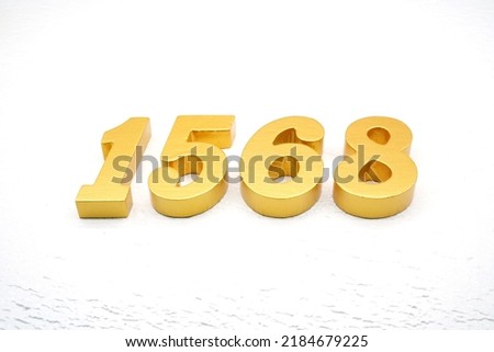    Number 1568 is made of gold painted teak, 1 cm thick, laid on a white painted aerated brick floor                           