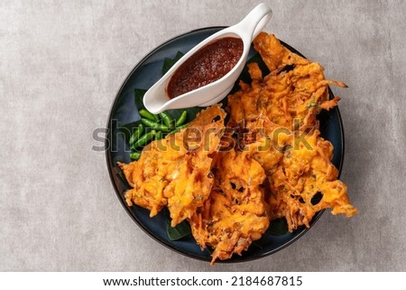 Bakwan is a vegetable fritter or gorengan from Indonesian cuisine.The ingredients are vegetables, usually beansprouts, shredded cabbages and carrots, battered and deep fried in cooking oil. Royalty-Free Stock Photo #2184687815