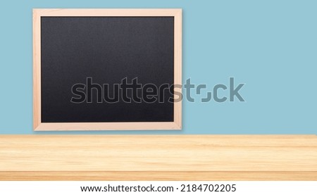 Minimal office or classroom interior with tabletop, desk and black board