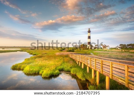 Part of the beautiful Cape Hatteras National Seashore, the Bodie Island Lighthouse is an Iconic Lighthouse of Nags Head Outer Banks North Carolina. This incredible stretch of coastal barrier islands a Royalty-Free Stock Photo #2184707395