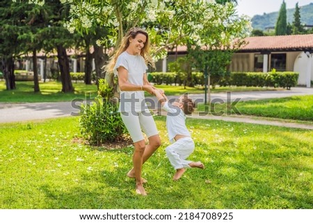 Young beautiful mother plays with her child outdoor Portrait of a disgruntled girl sitting at a cafe table