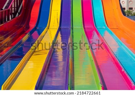 Close up abstract view of a large giant slide at the fairgrounds in rainbow colors