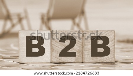 Business to Business concept. B2B letters on wooden cubes. Sunny beach and ocean background. Online business trading concept.