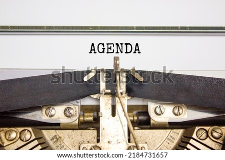 Business and agenda symbol. The concept word 'agenda' typed on retro typewriter. Beautiful white background. Business and agenda concept.