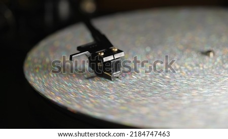 Retro-styled spinning silver record vinyl player. Close up glitter surface. Rotating vintage phonograph. Beautiful picture. Copy space,