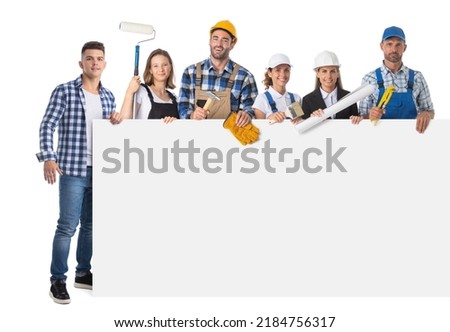 Portrait of happy construction workers holding blank banner isolated against white background