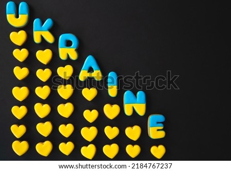 The word Ukraine on a black background, made with handmade gingerbread.