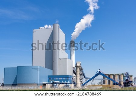 View of a large coal and biomass power plant on a clear summer day. Port of Rotterdam, the Netherlands. Royalty-Free Stock Photo #2184788469