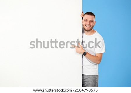 cheerful man holding board with empty copy space
