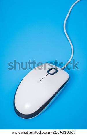 White computer mouse over blue background