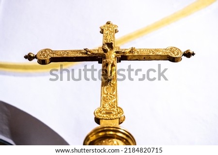 Gilded crucifix, viewed from below, gloriously decorated to appear wealthy.
