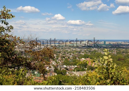 A picture of the lower city of Hamilton from the mountain, with the harbour in the background. 
