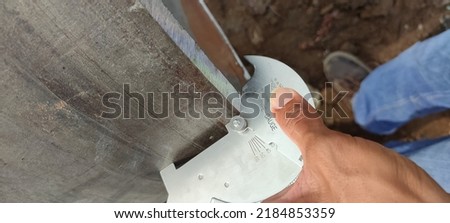 Control fit-up of pipe butt joints with crawl.It can be measured Angle, Excess weld metal (capping size), Undercut Depth, Pitting Depth, Fillet Weld Throat Size, Fillet Weld Length, Misalignment (High Royalty-Free Stock Photo #2184853359