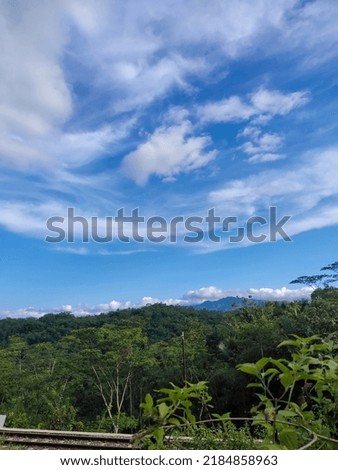 beautiful mountain view from afar with sunny and cloudy