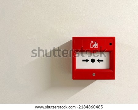 Bright red fire alarm test with light shadow isolated on white background. safety concept.