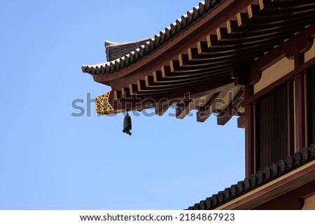 A bell to ward off evil hanging under the eaves of a temple Royalty-Free Stock Photo #2184867923