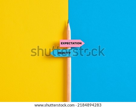 Reality vs expectation contrast or choice. Pencil with direction indicator stickers showing the distinction between expectations and reality. Royalty-Free Stock Photo #2184894283