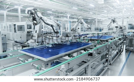 Wide Shot of Solar Panel Production Line with Robot Arms at Modern Bright Factory. Solar Panels are being Assembled on Conveyor. Royalty-Free Stock Photo #2184906737